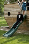 The groom goes down the slide